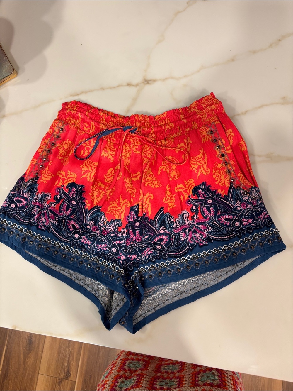 Free People multicolor drawstring shorts with beaded detailing.